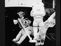 Figure 3.1. Astronauts at work: Jeff Hoffman on the manipulator arm with Story Musgrave wedged into the Hubble’s gyro compartment (Courtesy of NASA).
